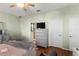 Bright main bedroom featuring wood-look floors, ceiling fan, and natural light at 8205 Sw 78Th Terrace Rd, Ocala, FL 34476
