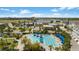 Aerial shot featuring the community pool area with cabanas, lounge chairs, and nearby recreational facilities at 8638 Finsen St, Orlando, FL 32827
