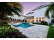 Spacious backyard featuring a modern pool with an in-water lounge chair and stylish landscaping at 8638 Finsen St, Orlando, FL 32827