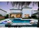 Expansive backyard featuring a modern pool with integrated water features and a covered patio at 8638 Finsen St, Orlando, FL 32827
