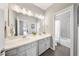 Modern bathroom with double sink vanity, stone countertops, and tile flooring plus shower at 8638 Finsen St, Orlando, FL 32827