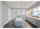 Modern bathroom featuring a soaking tub, dual vanities, and three glass enclosed shower stalls at 8638 Finsen St, Orlando, FL 32827