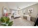 Well-lit bedroom with white bedding, light wood floors and a dedicated vanity area at 8638 Finsen St, Orlando, FL 32827