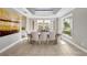 Elegant dining room featuring modern lighting, neutral tones, and large windows at 8638 Finsen St, Orlando, FL 32827