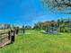 Well-maintained community dog park with lush green grass, a seating area, and secure fencing at 8638 Finsen St, Orlando, FL 32827