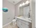 Cozy half-bathroom featuring modern fixtures, a stylish vanity, and charming decor at 8638 Finsen St, Orlando, FL 32827