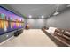 Comfortable home theater room with a large screen, projector, and plush seating at 8638 Finsen St, Orlando, FL 32827