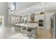 Bright, open kitchen with white cabinets, stainless steel appliances and large center island with bar stool seating at 8638 Finsen St, Orlando, FL 32827