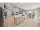 Open concept kitchen with stainless steel appliances and breakfast bar at 8638 Finsen St, Orlando, FL 32827