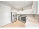 Well-equipped laundry room with stainless steel appliances, white cabinets, sink, and plenty of counter space at 8638 Finsen St, Orlando, FL 32827