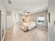 Light filled bedroom with hardwood floors, ceiling fan, and walk-in closet at 8638 Finsen St, Orlando, FL 32827