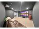 Home theater room with a large projector screen, comfortable seating and a vintage popcorn machine at 8638 Finsen St, Orlando, FL 32827