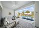 Covered patio with comfortable seating, offering a seamless transition to the outdoor pool and lush landscape at 8638 Finsen St, Orlando, FL 32827