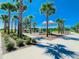 Community playground with shade, mature landscaping, and pedestrian paths at 8638 Finsen St, Orlando, FL 32827