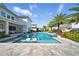 Stunning backyard pool with integrated loungers, stepping stones, and a covered patio for outdoor enjoyment at 8638 Finsen St, Orlando, FL 32827
