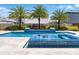 Beautiful pool with water feature surrounded by palm trees and manicured landscaping perfect for relaxation at 8638 Finsen St, Orlando, FL 32827