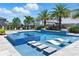 Luxury pool with a spa, stepping stones, and in-water loungers, set in a beautifully landscaped backyard at 8638 Finsen St, Orlando, FL 32827