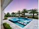 Stunning pool with stepping stones and fountains surrounded by lush landscaping and palm trees at 8638 Finsen St, Orlando, FL 32827