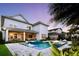 Beautiful backyard with a modern pool, in-water lounge chairs, and manicured landscaping at 8638 Finsen St, Orlando, FL 32827