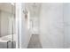 Luxurious shower with floor-to-ceiling tile, dual shower heads, and glass door at 8638 Finsen St, Orlando, FL 32827