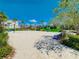 Community sand volleyball court surrounded by tropical landscaping and shaded seating areas at 8638 Finsen St, Orlando, FL 32827