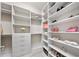 Bright walk-in closet with custom shelving and drawers for optimal organization at 8638 Finsen St, Orlando, FL 32827