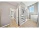 Bright walk-in closet features custom shelving, cabinets, and hardwood flooring, offering ample storage and organization at 8638 Finsen St, Orlando, FL 32827