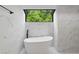 Bright, white bathroom boasts modern tub, black accents, large window, and sleek fixtures at 1012 Willa Lake Cir, Oviedo, FL 32765