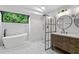 Bright bathroom features freestanding tub, glass shower, marble tile, and modern vanity at 1012 Willa Lake Cir, Oviedo, FL 32765