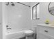 Modern bathroom with marble tile, shower, tub, and updated fixtures at 1012 Willa Lake Cir, Oviedo, FL 32765
