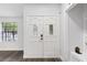 Bright entryway features a stylish white double door with decorative glass inserts and dark wood floors at 1012 Willa Lake Cir, Oviedo, FL 32765