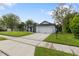 A suburban home featuring a two car garage with white paneling and a well manicured lawn at 1012 Willa Lake Cir, Oviedo, FL 32765