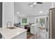 Open kitchen, dining and living space featuring stainless appliances, bar seating and backyard views at 1012 Willa Lake Cir, Oviedo, FL 32765