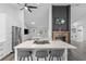 Bright modern kitchen featuring a large island with seating, stainless steel refrigerator and hardwood floors at 1012 Willa Lake Cir, Oviedo, FL 32765