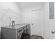Convenient laundry room with modern washer and dryer, storage shelf, and door to the side at 1012 Willa Lake Cir, Oviedo, FL 32765