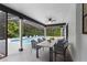 Covered patio with dining table looking out to the screened pool and backyard at 1012 Willa Lake Cir, Oviedo, FL 32765