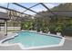 Relaxing screened pool featuring beautiful blue tiled trim and lush greenery providing a private backyard setting at 1012 Willa Lake Cir, Oviedo, FL 32765
