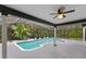 A lovely outdoor covered patio area with a view of the pool and greenery at 1012 Willa Lake Cir, Oviedo, FL 32765