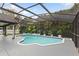 Relaxing screened pool featuring beautiful blue tiled trim and lush greenery providing a private backyard setting at 1012 Willa Lake Cir, Oviedo, FL 32765