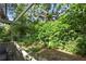 Lush backyard with green hedges and mature trees offers a private outdoor space at 102 Fairway Dr # 102, Longwood, FL 32779