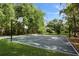 Outdoor basketball court surrounded by trees, offering a great recreational space at 102 Fairway Dr # 102, Longwood, FL 32779