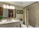 Well-lit bathroom with vanity, updated faucet, framed mirror, and shower-tub with curtain at 102 Fairway Dr # 102, Longwood, FL 32779