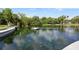 Scenic community lake with clear water, lush greenery, and a floating dock, perfect for relaxation at 102 Fairway Dr # 102, Longwood, FL 32779