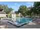 Inviting community pool surrounded by lush landscaping and comfortable lounge chairs for relaxation at 102 Fairway Dr # 102, Longwood, FL 32779