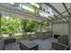 Outdoor deck area with patio furniture surrounded by lush greenery and shade at 102 Fairway Dr # 102, Longwood, FL 32779