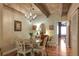 A bright dining room with a wooden table and chairs, with an adjacent kitchen at 102 Fairway Dr # 102, Longwood, FL 32779