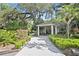 Long driveway leads to a covered entrance with well manicured landscaping and mature trees at 102 Fairway Dr # 102, Longwood, FL 32779