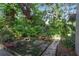 A beautiful outdoor garden spot on this property, with a bench and stone path at 102 Fairway Dr # 102, Longwood, FL 32779