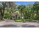 A charming guard house welcomes residents, set amidst meticulously landscaped grounds and mature trees at 102 Fairway Dr # 102, Longwood, FL 32779