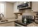 Modern kitchen features granite countertops, stainless steel appliances, and ample cabinet space at 102 Fairway Dr # 102, Longwood, FL 32779